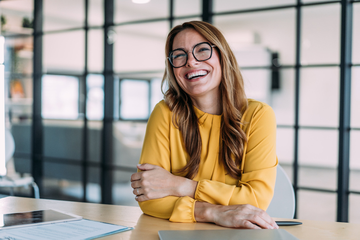 Confident businesswoman in modern office. Relief